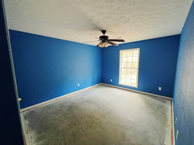 spare room featuring ceiling fan and a textured ceiling