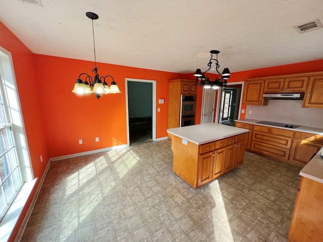 kitchen with pendant lighting, a notable chandelier, and a kitchen island