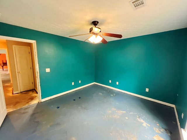 spare room with concrete floors and ceiling fan