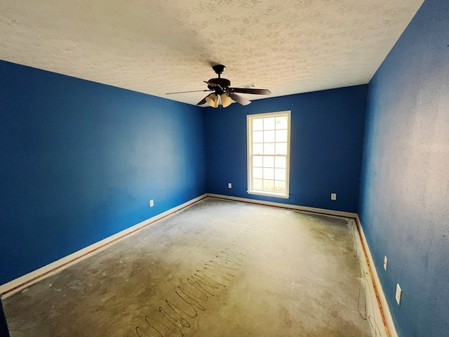 unfurnished room with ceiling fan and a textured ceiling