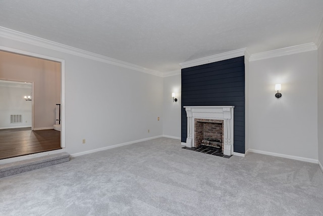 unfurnished living room featuring carpet, baseboards, visible vents, a fireplace, and ornamental molding