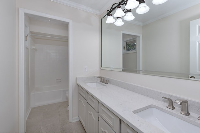 full bath with double vanity, ornamental molding, an inviting chandelier, and a sink