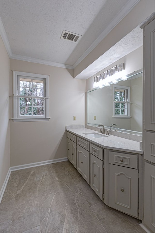 bathroom featuring visible vents, vanity, a textured ceiling, and crown molding