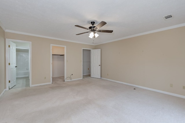 unfurnished bedroom featuring a textured ceiling, baseboards, visible vents, and ornamental molding