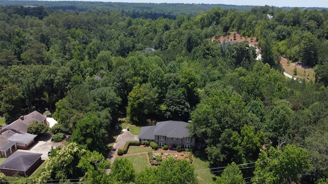 birds eye view of property with a forest view