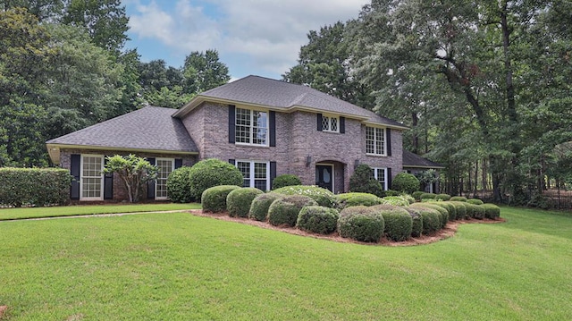 colonial house with brick siding and a front yard