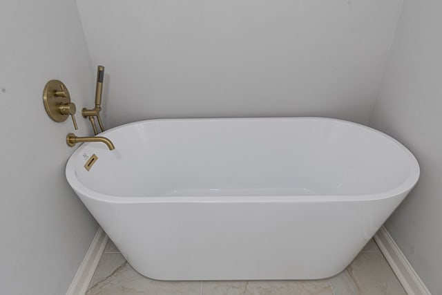 interior details featuring baseboards and a soaking tub