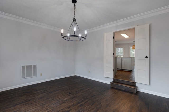 empty room with visible vents, ornamental molding, dark wood-style floors, an inviting chandelier, and baseboards