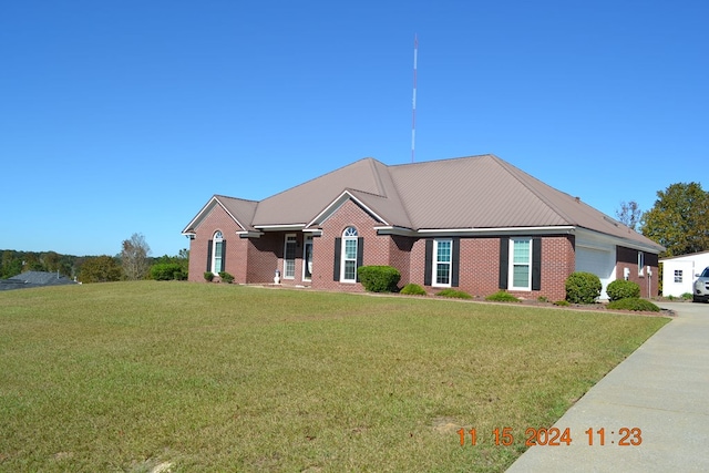 ranch-style home with a front lawn and a garage