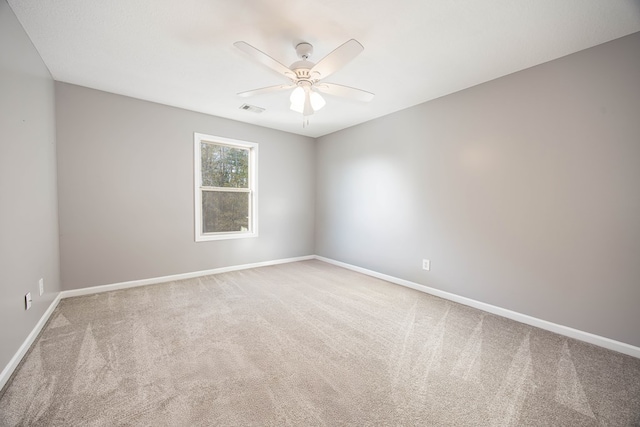 carpeted empty room featuring ceiling fan