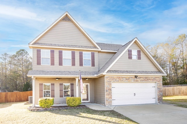 view of front of house with a garage and central AC unit