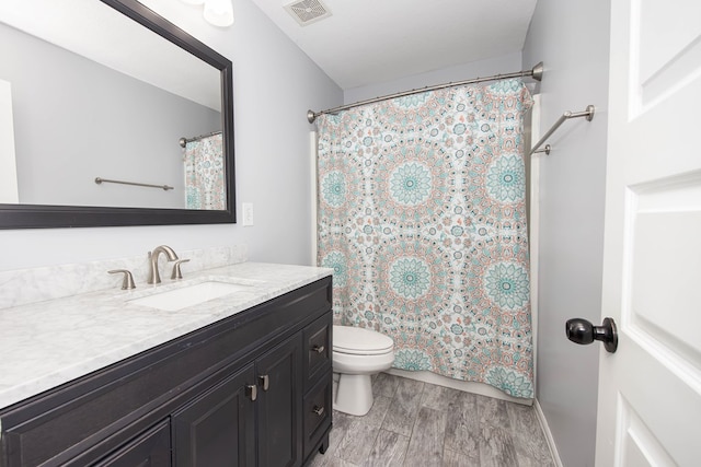 bathroom featuring hardwood / wood-style floors, vanity, and toilet