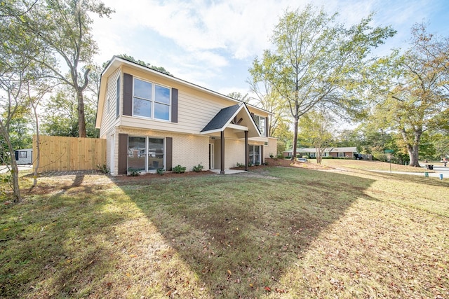 view of property featuring a front lawn