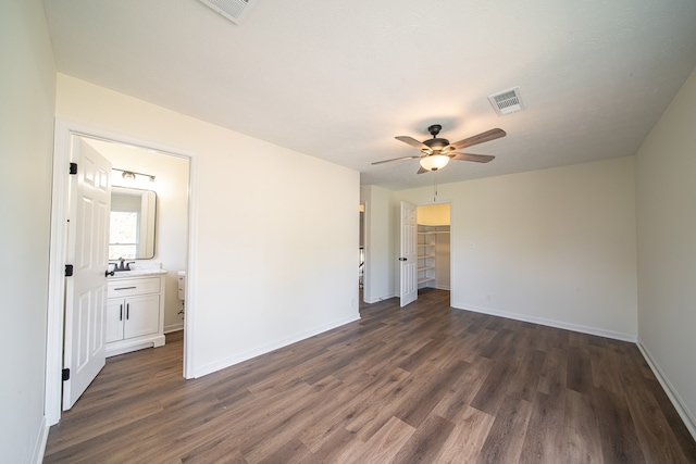 spare room with ceiling fan, sink, and dark hardwood / wood-style floors