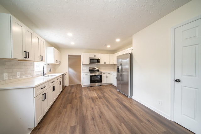 kitchen with white cabinetry, sink, dark hardwood / wood-style floors, and appliances with stainless steel finishes