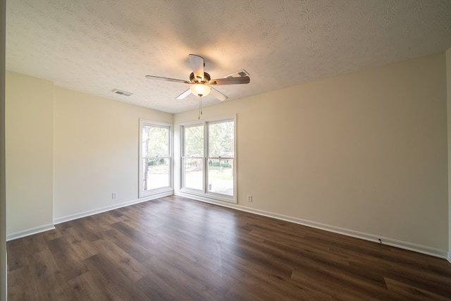 spare room featuring ceiling fan, dark hardwood / wood-style flooring, and a textured ceiling