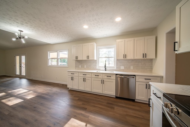 kitchen with sink, dark hardwood / wood-style flooring, white cabinets, and appliances with stainless steel finishes