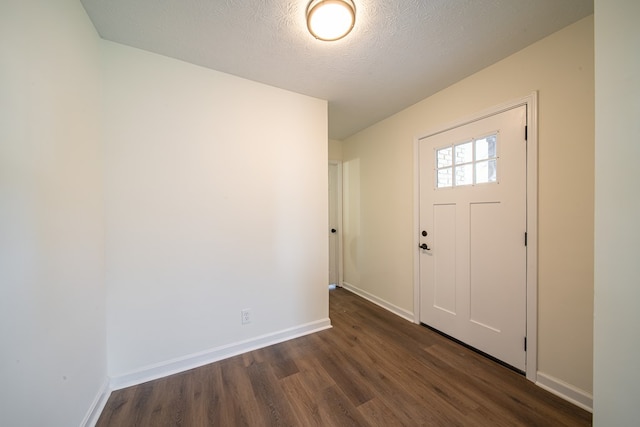 entrance foyer featuring a textured ceiling and dark hardwood / wood-style floors