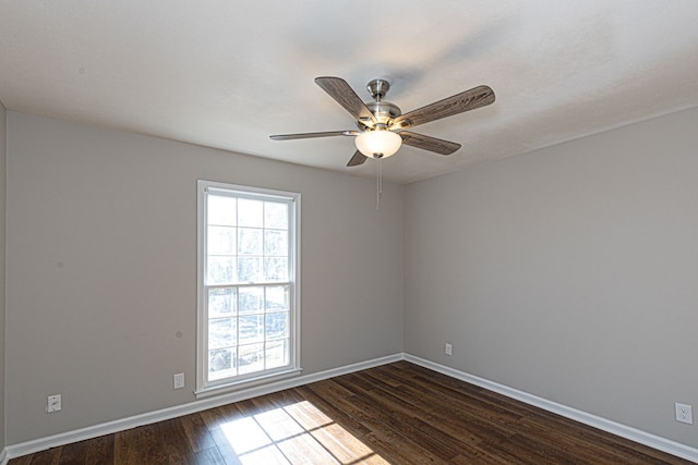 unfurnished room with dark wood-style floors, ceiling fan, baseboards, and a healthy amount of sunlight