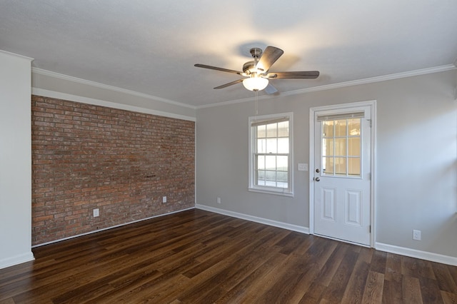 unfurnished room featuring ornamental molding, brick wall, dark wood-type flooring, and baseboards