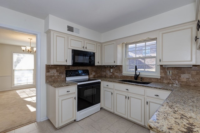 kitchen featuring visible vents, light stone countertops, black microwave, a sink, and range with electric stovetop