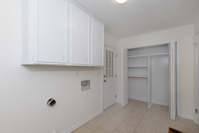 laundry room featuring light tile patterned floors, hookup for a washing machine, cabinet space, and baseboards