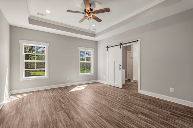 204 Lee Rd Unit 0334, Salem, AL 36874 - unfurnished bedroom with baseboards, a barn door, wood finished floors, and a raised ceiling