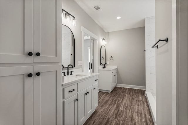 204 Lee Rd Unit 0334, Salem, AL 36874 - full bath featuring visible vents, baseboards, wood finished floors, two vanities, and a sink