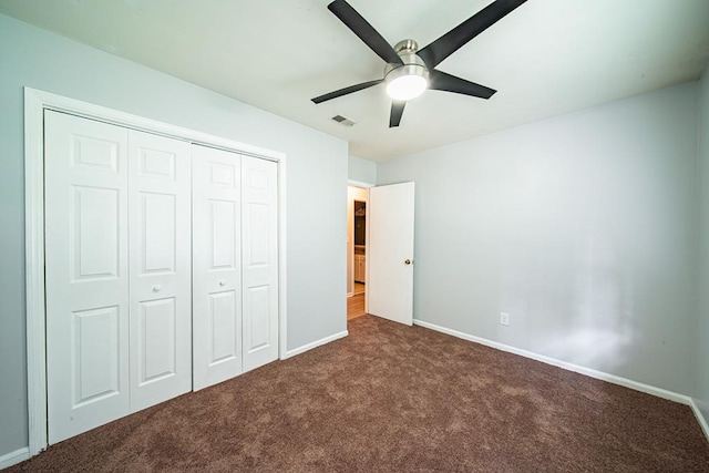 unfurnished bedroom with a closet, ceiling fan, carpet flooring, baseboards, and visible vents