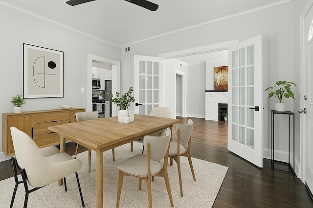 2901 Peabody Ave, Columbus, GA 31904 - dining area with dark wood-style flooring, a ceiling fan, ornamental molding, and a fireplace