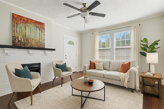 2901 Peabody Ave, Columbus, GA 31904 - living area featuring wood finished floors, crown molding, a fireplace, a ceiling fan, and a textured ceiling