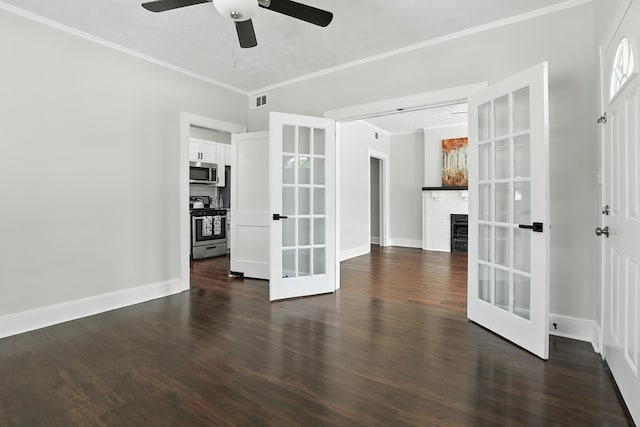 2901 Peabody Ave, Columbus, GA 31904 - empty room with french doors, dark wood finished floors, ceiling fan, ornamental molding, and a brick fireplace