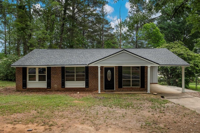 8344 Twin Chapel Dr, Columbus, GA 31904 - ranch-style home with roof with shingles, concrete driveway, an attached carport, and brick siding