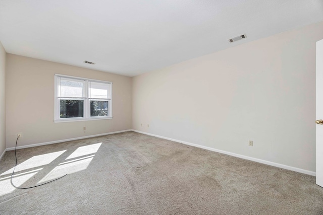 unfurnished room featuring light colored carpet