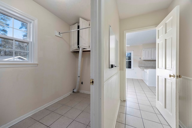 laundry room featuring light tile patterned floors and hookup for an electric dryer