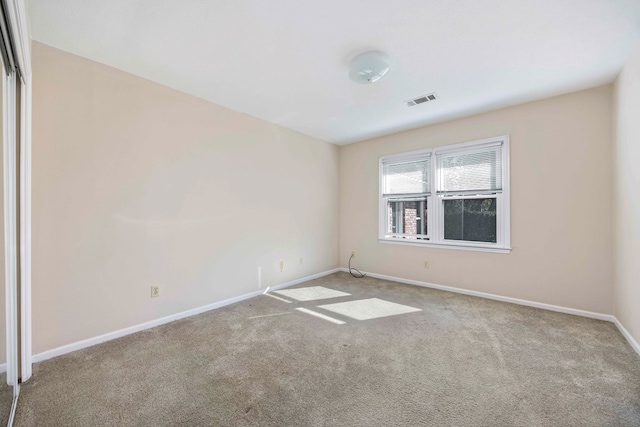 unfurnished room with light colored carpet