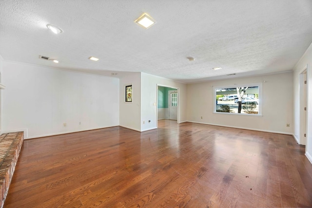 unfurnished room featuring a textured ceiling and dark wood-type flooring