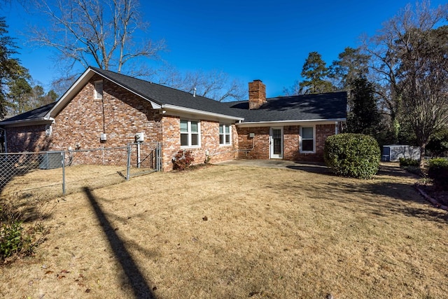 rear view of property featuring a yard and central air condition unit