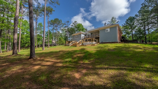 view of yard featuring stairway and a deck