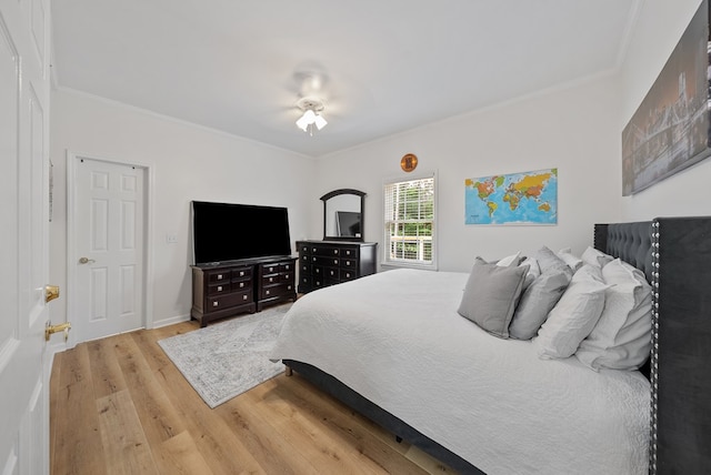 bedroom featuring ornamental molding and wood finished floors