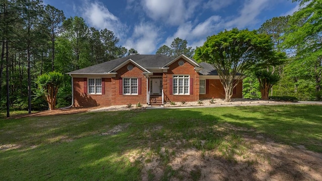 ranch-style house featuring brick siding and a front yard