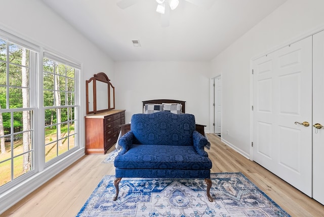 living area featuring visible vents, a ceiling fan, and light wood-style flooring