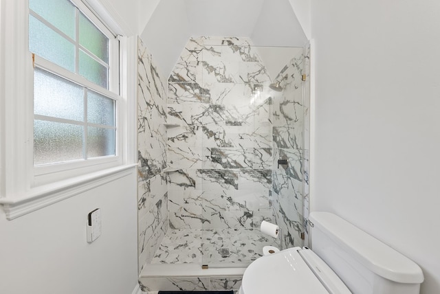 full bathroom featuring a stall shower and toilet