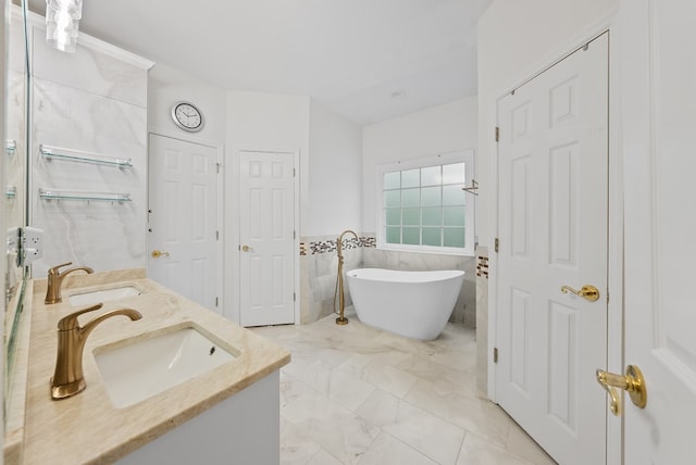 full bath with a sink, tile walls, double vanity, and a freestanding bath