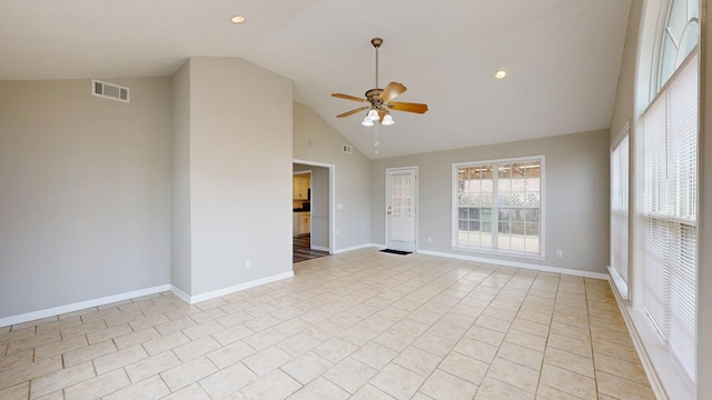 tiled empty room with ceiling fan and high vaulted ceiling