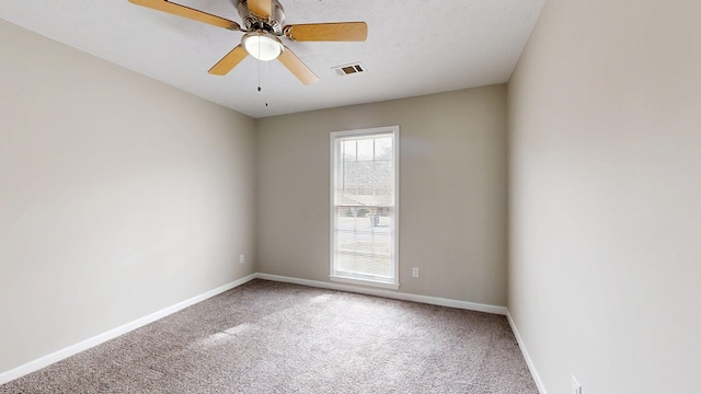 spare room with carpet floors, a textured ceiling, and ceiling fan