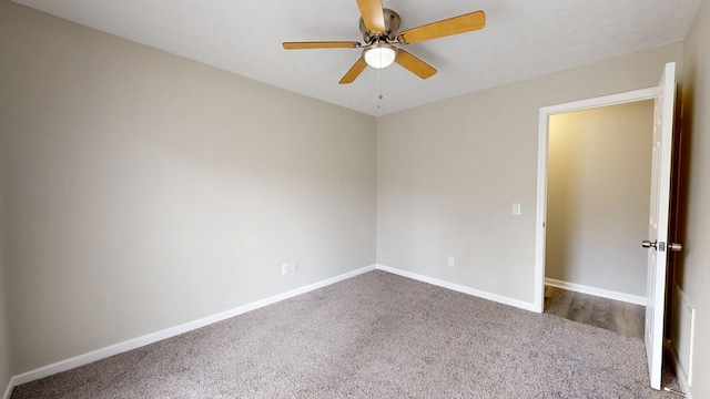 spare room featuring ceiling fan and carpet