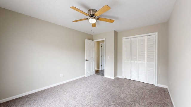 unfurnished bedroom with carpet floors, a closet, and ceiling fan