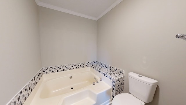 bathroom with ornamental molding, a bathing tub, and toilet