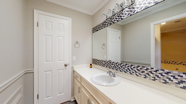 bathroom with vanity, ornamental molding, and backsplash